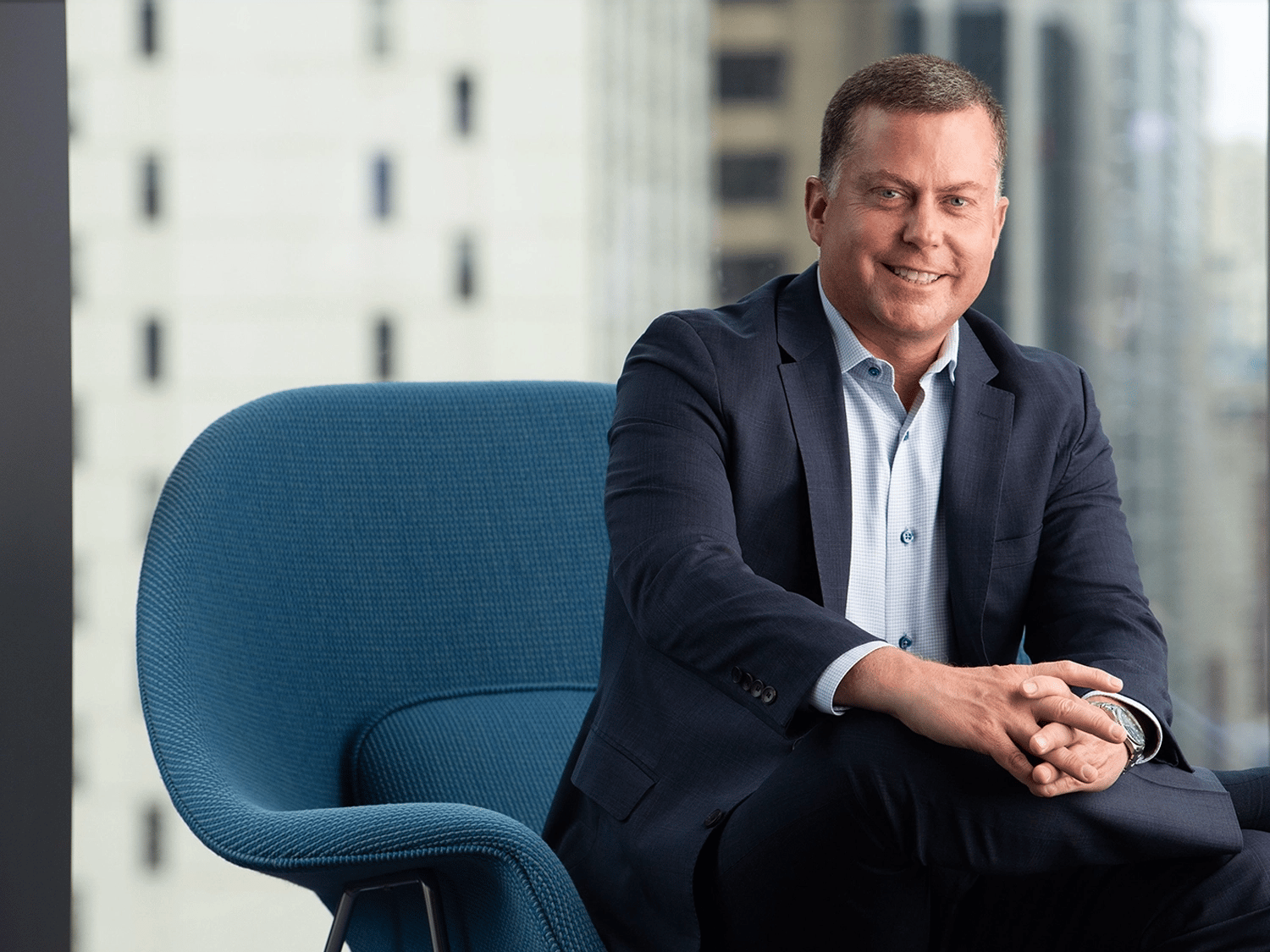 A professional portrait of Brock Johnson in the Chicago Morningstar office.