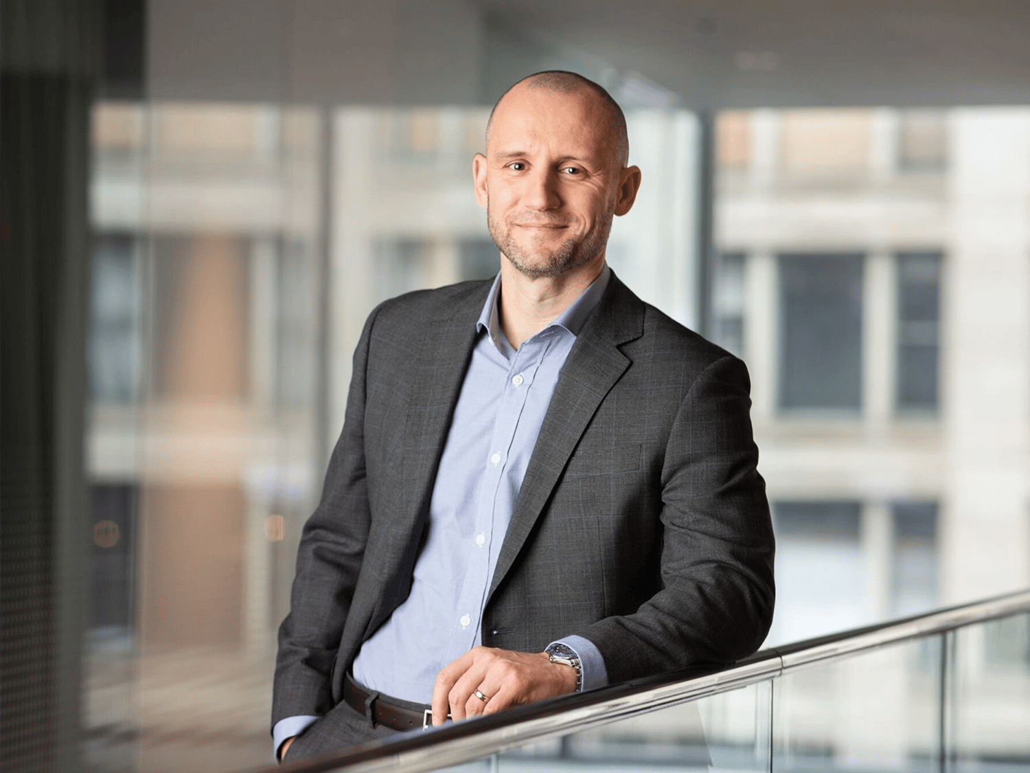 A professional portrait of Daniel Needham in the Chicago Morningstar office.